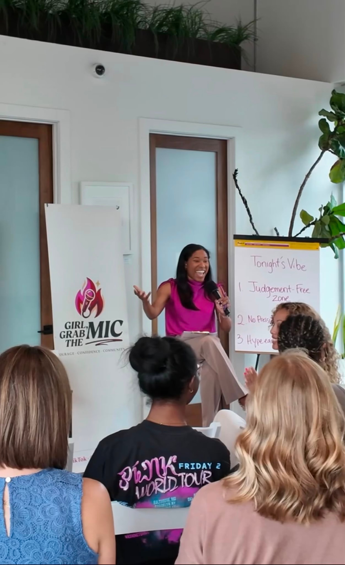 A woman speaking into the mic at a Girl, Grab the Mic gathering
